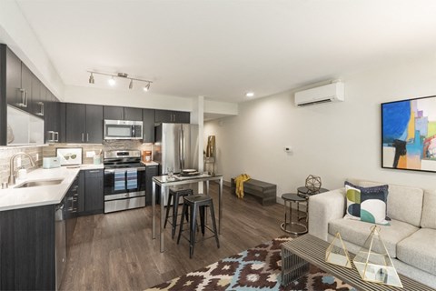 a living room with a kitchen and a couch and a table